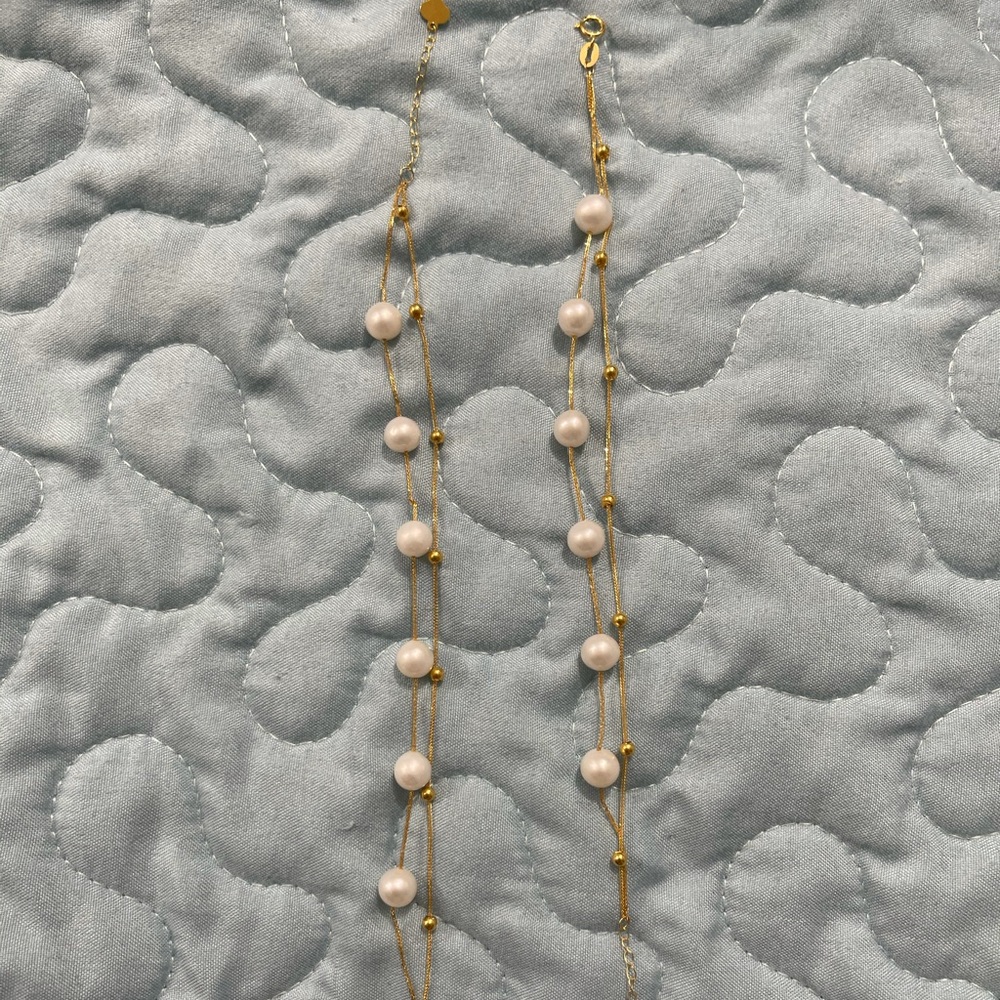 Two strand fresh water pearl bracelet in 18k gold setting